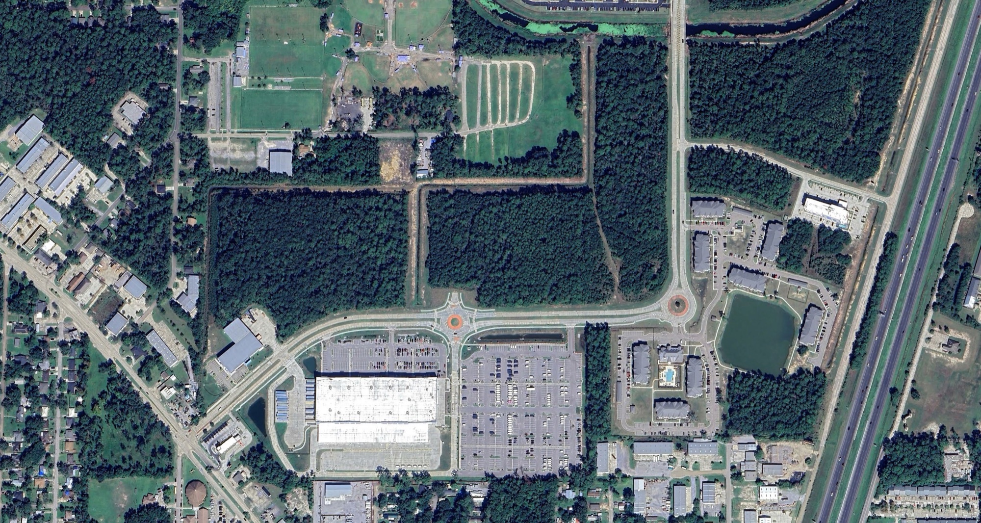Aerial view of the Rivermark Crossing sites on Town Center Parkway at Fremaux Park, with the Amazon Distribution Center below and I-10 to the east